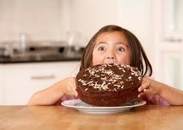 Little Girl about to Chomp Down on Big Chocolate Cake