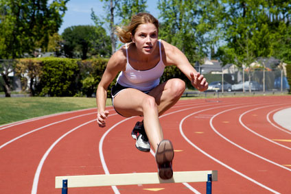 Woman Jumping a Track Hurdle