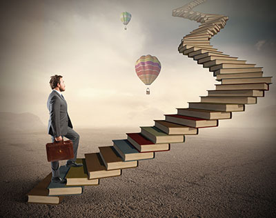 Businessman Climbing a Staircase of Books