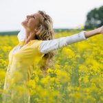 Joyful Optimistic Woman in Yellow Field