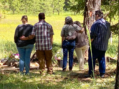 Family Grieving at Burial in The Forest